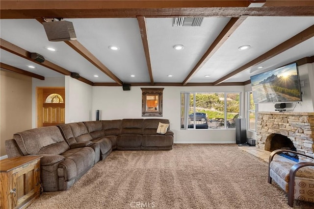 living room featuring beam ceiling, carpet flooring, a stone fireplace, and baseboards