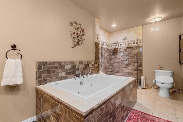 bathroom with tile patterned floors, toilet, a tub with jets, and a tile shower