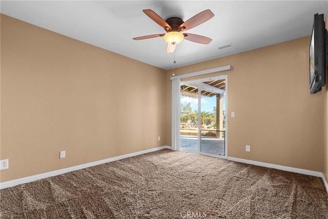 spare room with a ceiling fan, baseboards, visible vents, and carpet floors