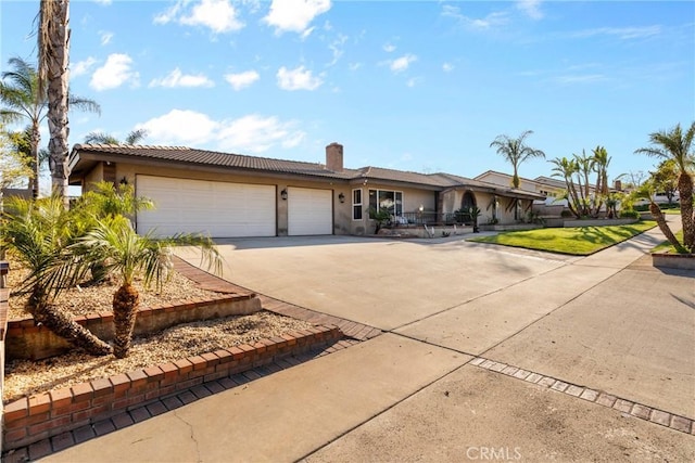 single story home with an attached garage, a chimney, stucco siding, concrete driveway, and a tile roof