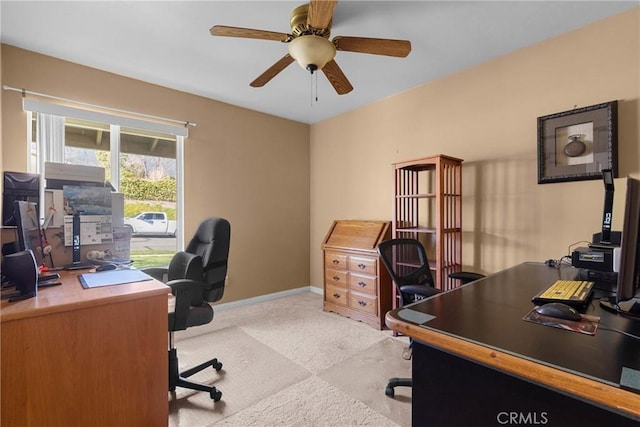 office area with light carpet, baseboards, and ceiling fan