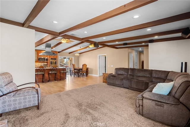 living room featuring lofted ceiling with beams, light wood-style flooring, recessed lighting, ceiling fan, and light carpet