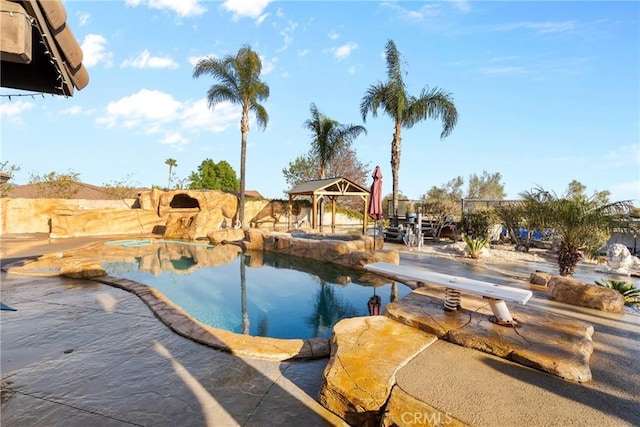 view of pool with a gazebo, a jacuzzi, and a diving board