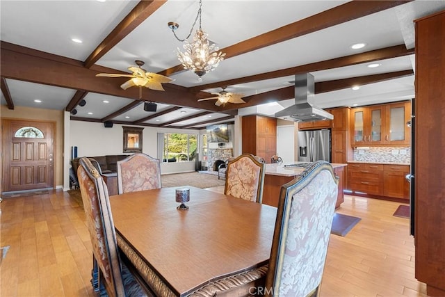 dining area with beamed ceiling, recessed lighting, ceiling fan with notable chandelier, and light wood-style floors