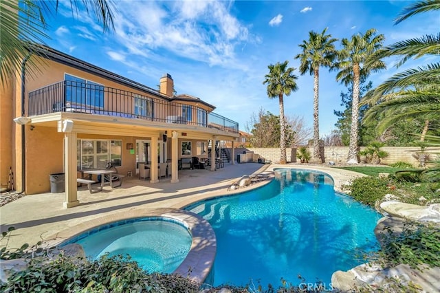 view of swimming pool featuring a fenced in pool, a patio area, fence, an in ground hot tub, and stairs