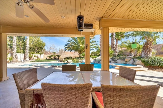 view of patio / terrace featuring a fenced in pool, outdoor dining area, a fenced backyard, and ceiling fan