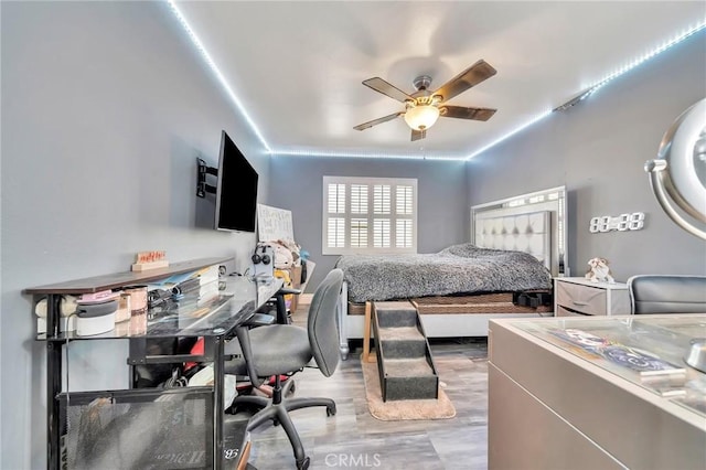 bedroom with a ceiling fan and wood finished floors