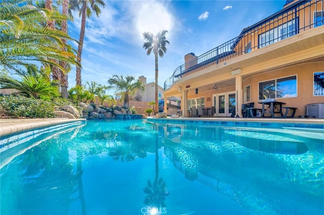 pool with a ceiling fan, french doors, a patio, and central AC unit