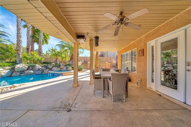 view of patio / terrace featuring ceiling fan, outdoor dining area, fence, and an outdoor pool