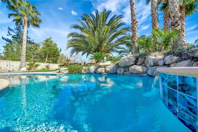 view of swimming pool with a fenced in pool and fence