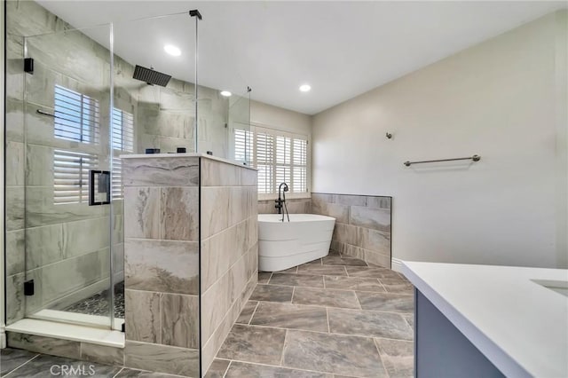 full bathroom featuring recessed lighting, a soaking tub, tile walls, and a shower stall