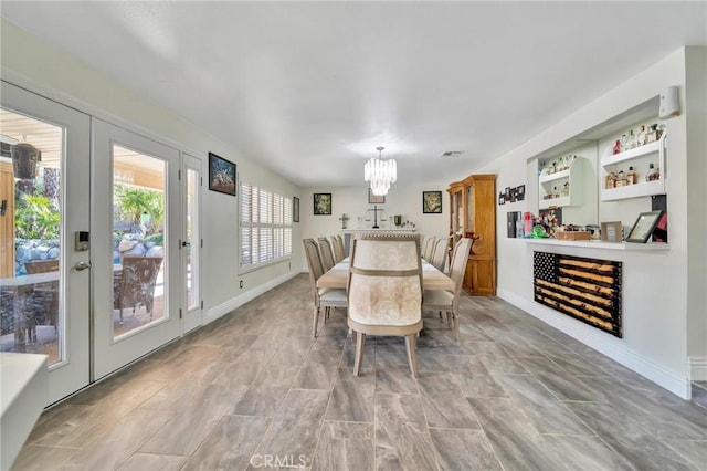 dining space with baseboards and an inviting chandelier