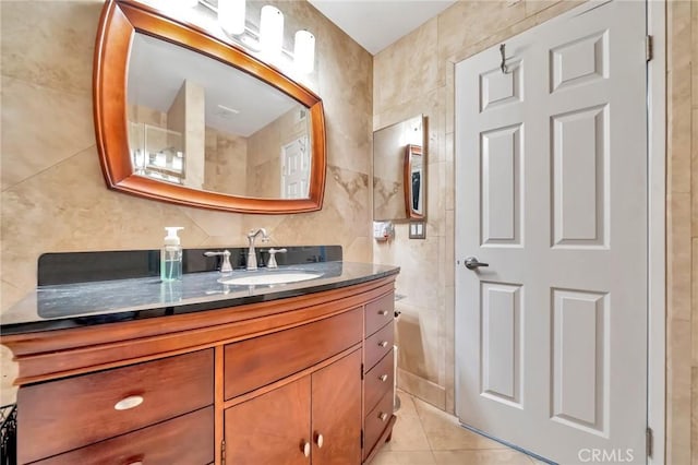 bathroom with tile patterned flooring, tile walls, and vanity