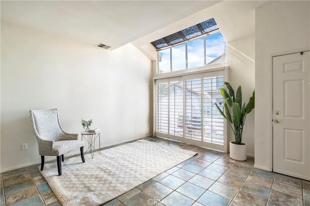 sitting room with visible vents and baseboards