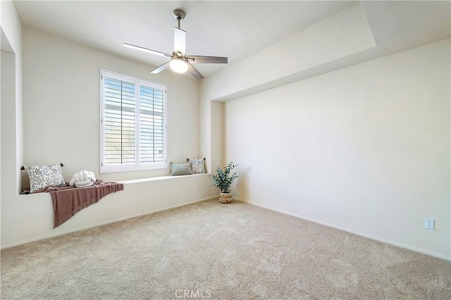 empty room with ceiling fan, baseboards, and carpet flooring