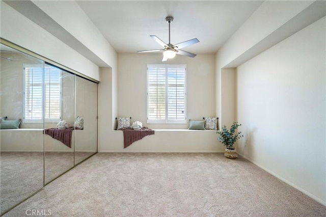 unfurnished bedroom featuring carpet, a closet, multiple windows, and baseboards