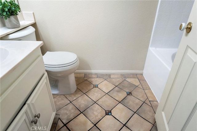 bathroom with toilet, a bathing tub, tile patterned flooring, and vanity