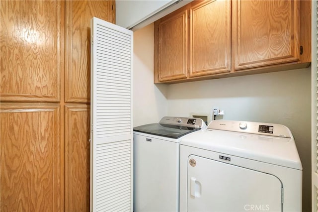 washroom with cabinet space and independent washer and dryer