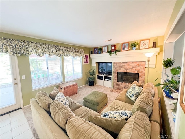 living area with light tile patterned floors, baseboards, light carpet, and a fireplace