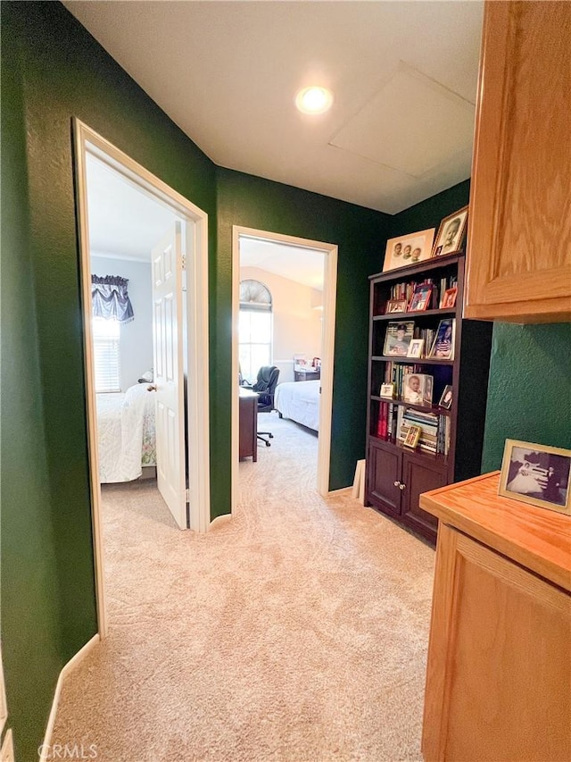 interior space with baseboards and light colored carpet