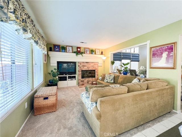 carpeted living room featuring visible vents, baseboards, a brick fireplace, and tile patterned flooring