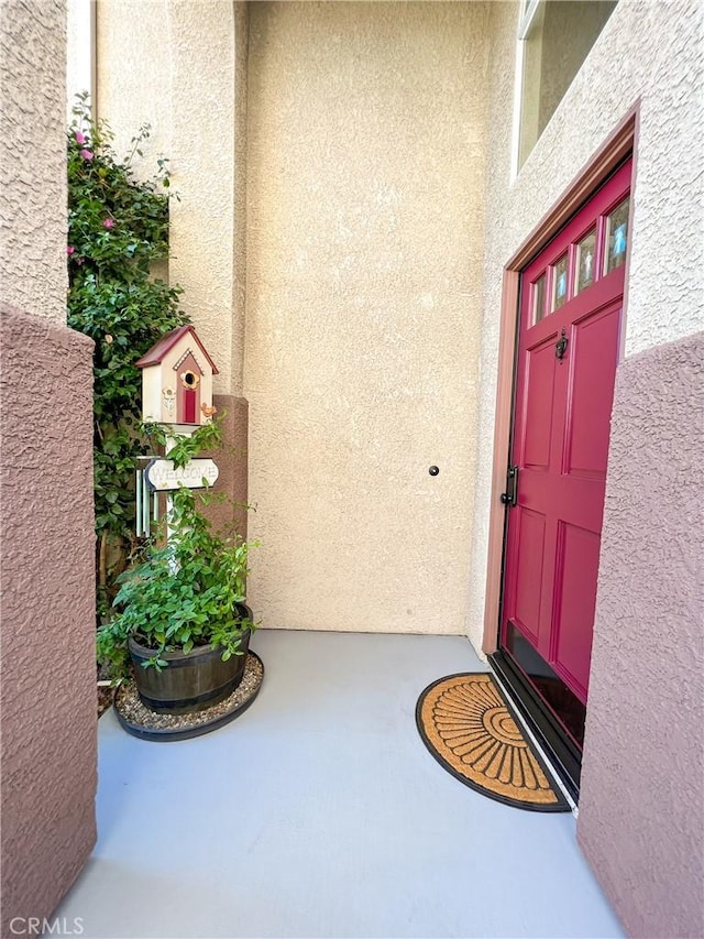 property entrance featuring stucco siding