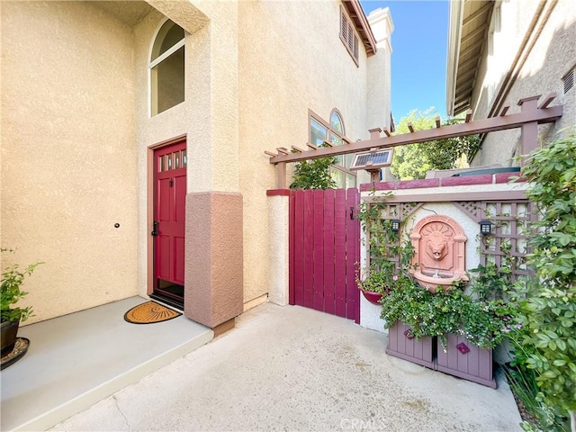 entrance to property featuring stucco siding