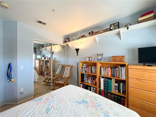 carpeted bedroom with baseboards, visible vents, and a closet