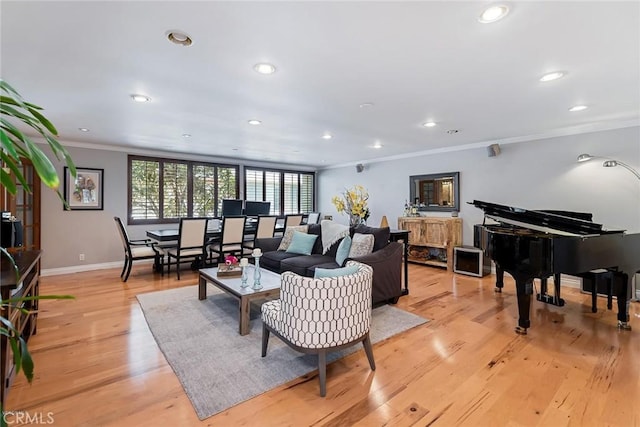 living room with baseboards, recessed lighting, light wood-type flooring, and ornamental molding