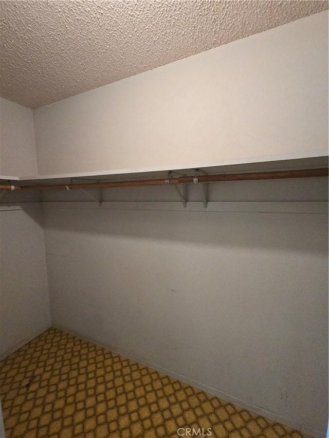 spacious closet with tile patterned floors