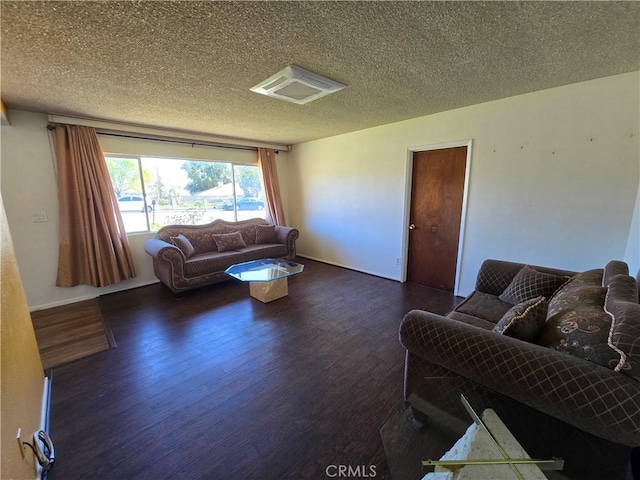 living area with a textured ceiling and wood finished floors