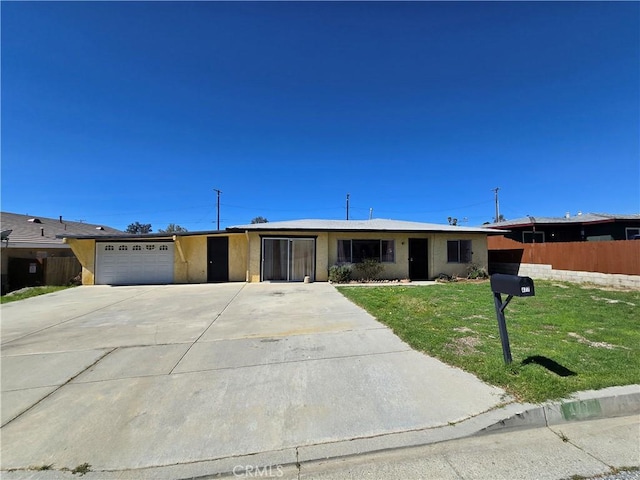 ranch-style home featuring an attached garage, driveway, a front yard, and fence