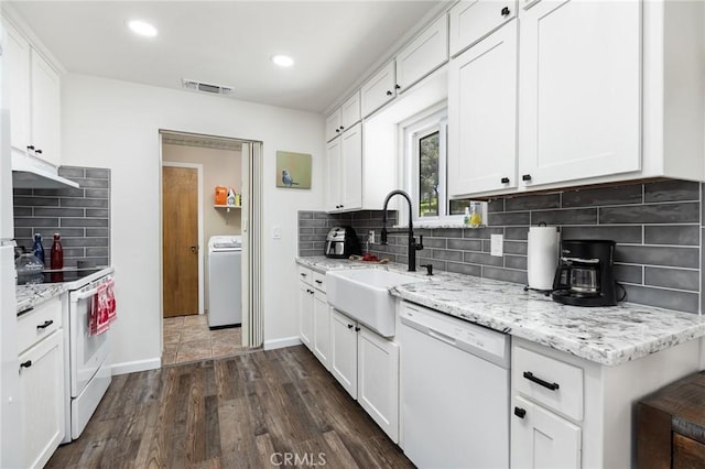 kitchen with white appliances, washer / clothes dryer, a sink, and white cabinets