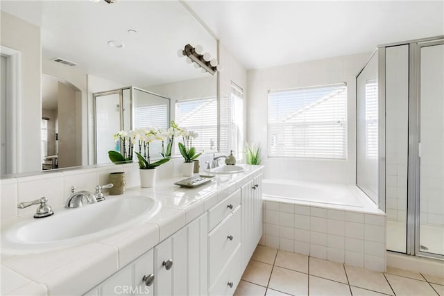 bathroom featuring a shower stall, visible vents, a sink, and tile patterned floors