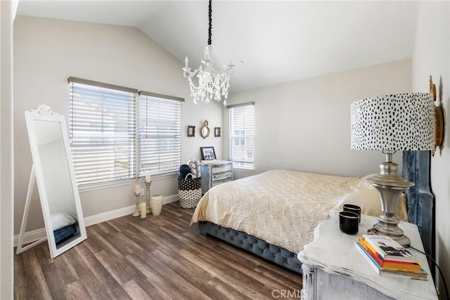 bedroom with lofted ceiling, an inviting chandelier, wood finished floors, and baseboards