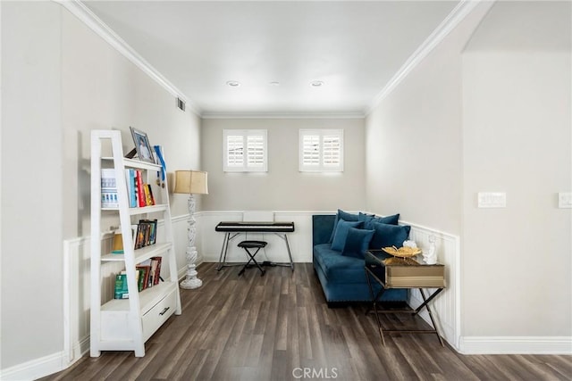 sitting room featuring ornamental molding, dark wood-style flooring, and baseboards