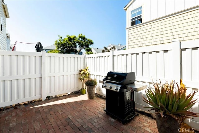 view of patio / terrace featuring a fenced backyard and a grill