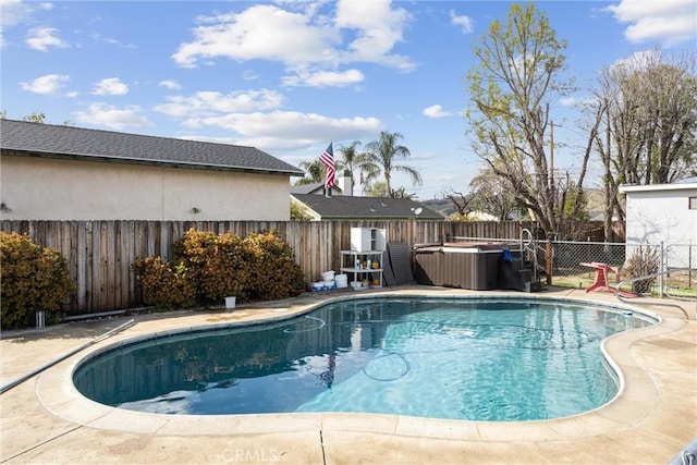 view of pool featuring a fenced in pool, a fenced backyard, and a hot tub