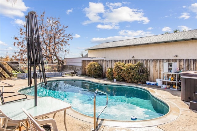 view of pool featuring a patio, a fenced backyard, and a fenced in pool