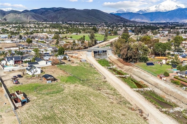 birds eye view of property with a mountain view