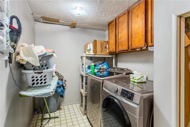 laundry area with cabinet space, a textured ceiling, light floors, and separate washer and dryer