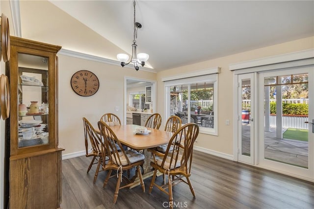 dining room with vaulted ceiling, baseboards, dark wood finished floors, and a notable chandelier