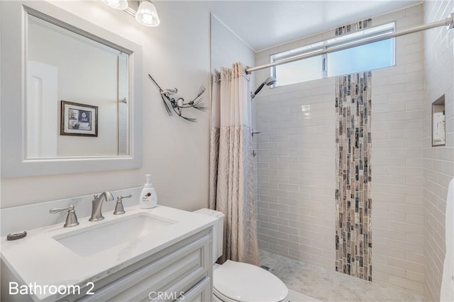 bathroom featuring a stall shower, vanity, and toilet