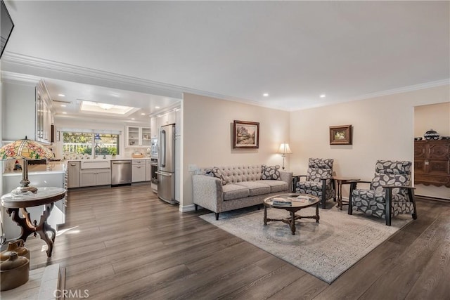 living room with dark wood-type flooring, recessed lighting, ornamental molding, and a skylight