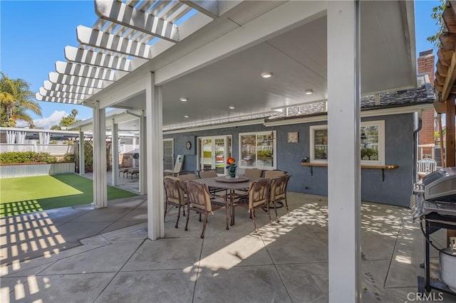 view of patio with fence, outdoor dining area, and a pergola