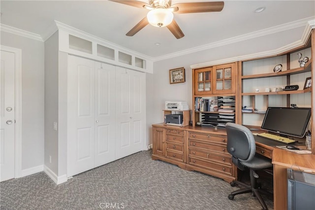 carpeted office space featuring ceiling fan, baseboards, and crown molding