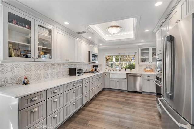 kitchen featuring recessed lighting, stainless steel appliances, a sink, and wood finished floors