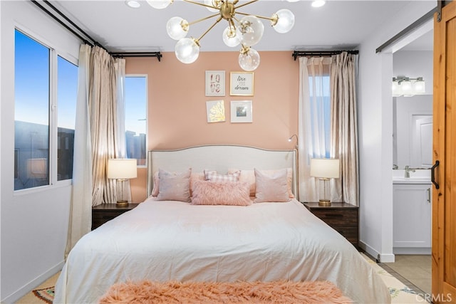 bedroom featuring baseboards, a sink, and tile patterned floors