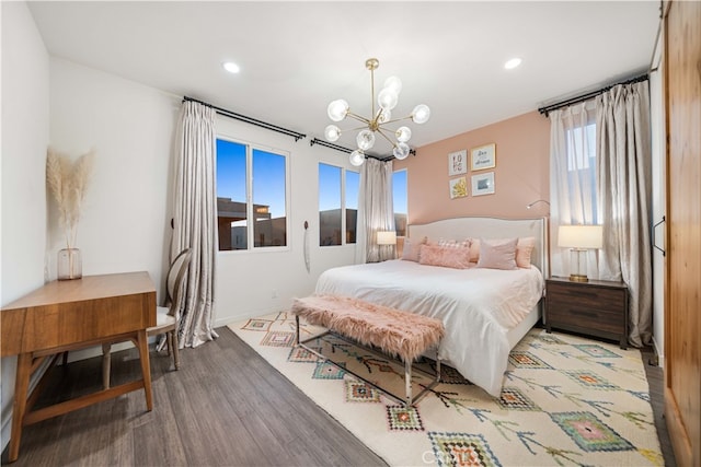 bedroom featuring a notable chandelier, wood finished floors, and recessed lighting