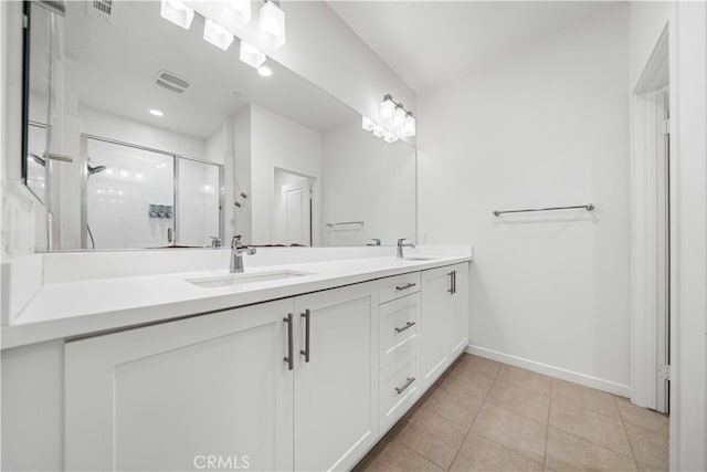 full bathroom featuring double vanity, visible vents, a sink, a shower stall, and tile patterned floors